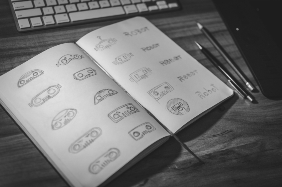 Sketchbook full of hand-drawn logo concepts, representing startup branding and logo design