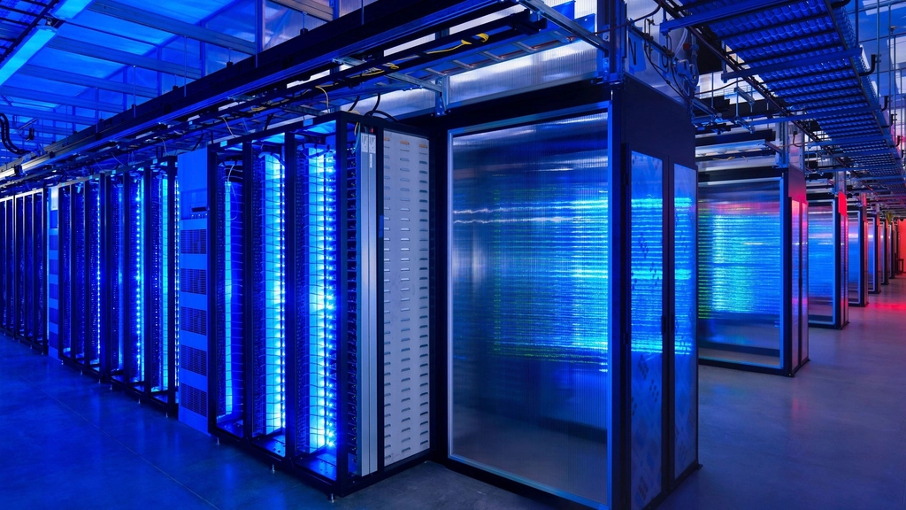 Rows of illuminated server racks in a cloud data center