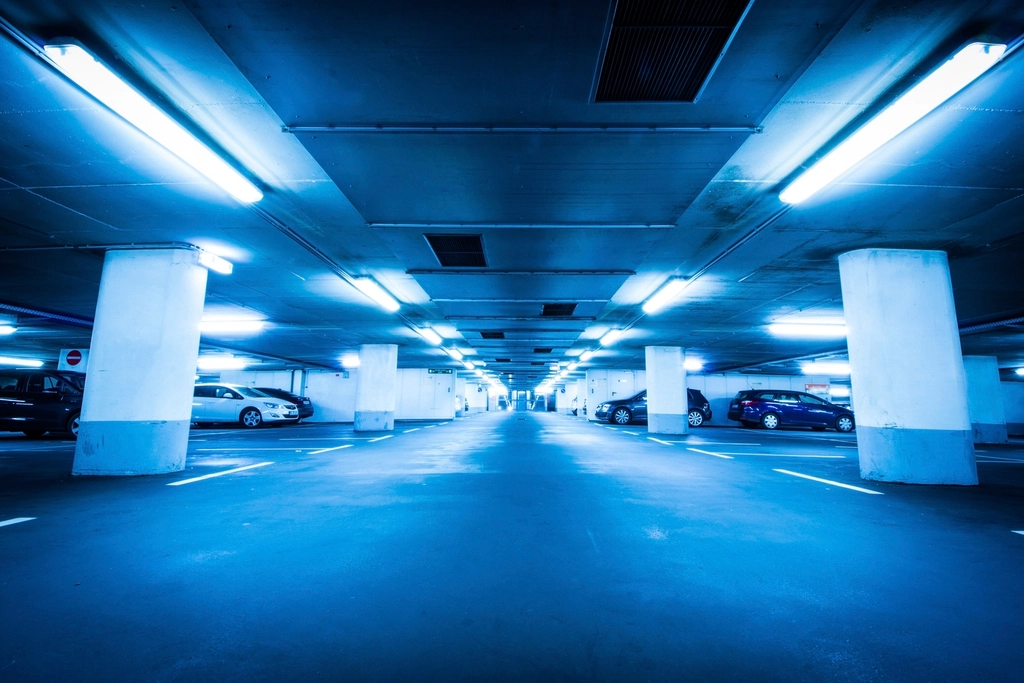 Cars parked in marked bays inside a modern underground parking garage
